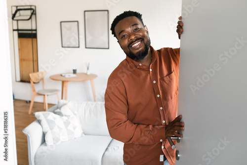 Принти на полотні African Man Opening Door Smiling To Camera Standing At Home