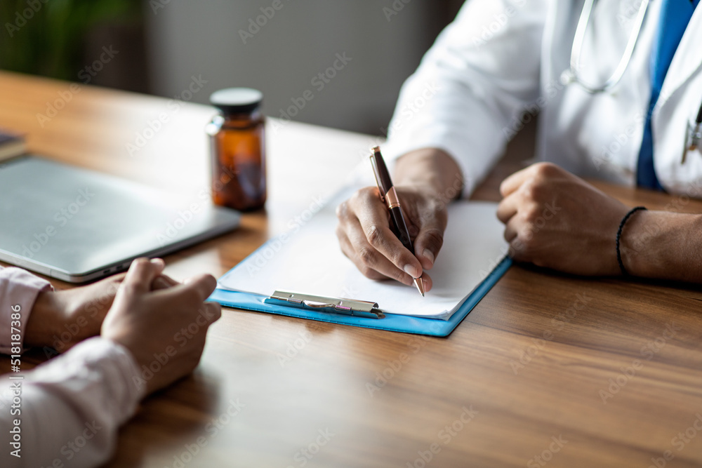 Unrecognizable doctor taking anamnesis of female patient Unrecognizable doctor taking anamnesis of female patient