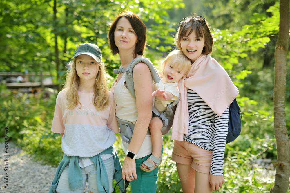 Φωτογραφία Young mother and her three kids hiking in Strazyska Valley in Tatra Mountain range, Podhale, Poland