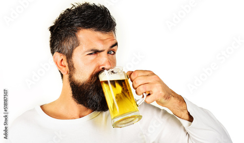 Oktoberfest. Bearded man drinking mug of beer. Alcohol, bad habit. Brewing. Stylish guy at cafe pub.