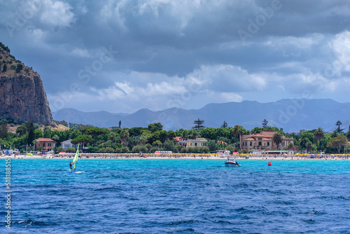 View from the sea of the bay and Mondello beach, motor boat anchored in the bay