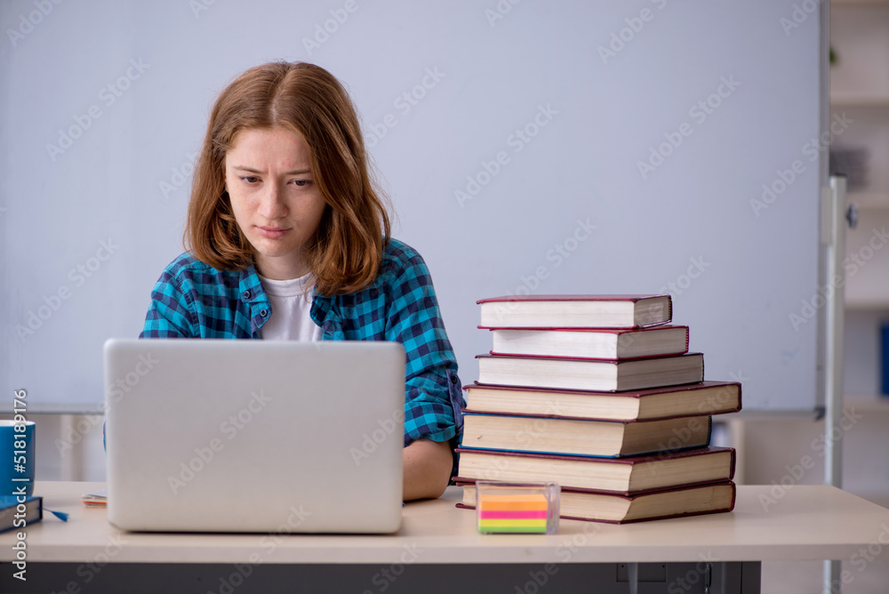 Young female student preparing for exams in the classroom Young female student preparing for exams in the classroom
