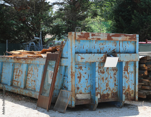 large blue container for the collection of wood and wooden window frames in the landfill of the controlled recycling center photo