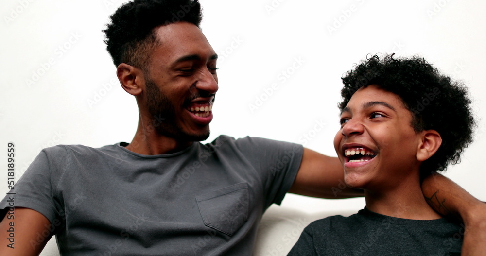 Obraz premium Two brothers relationship laughing and smiling together. Older and younger siblings bonding