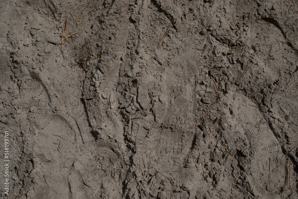 Footprints from shoes after walking on the ground. Selective focus