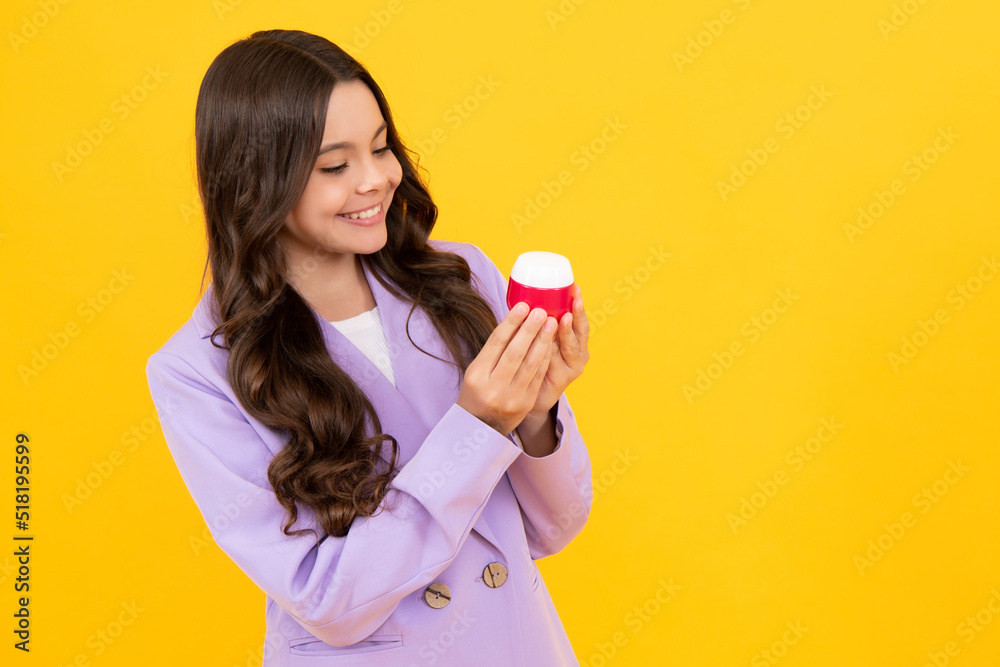 Child hold facial cleaner for skin wash. Skin care. Child presenting cosmetic product for teen. Kid use face cream. Child hold facial cleaner for skin wash. Skin care. Child presenting cosmetic product for teen. Kid use face cream.