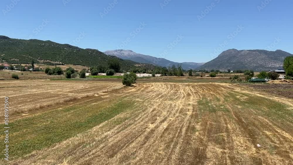 mountain ranges behind mown fields. foothills of the Taurus Mountains. mountain ranges behind mown fields. foothills of the Taurus Mountains.