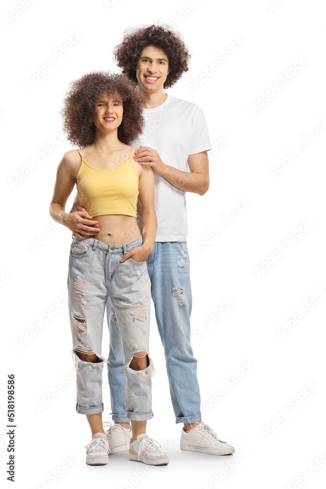 Full length portrait of a young man and woman with curly hair smiling and posing Full length portrait of a young man and woman with curly hair smiling and posing