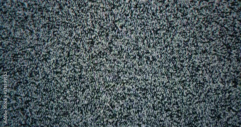 Close-up of old analog TV screen broadcasting white noise. Concept of media zombification and utility bills. Cable television was turned off for non-payment. Close-up of old analog TV screen broadcasting white noise. Concept of media zombification and utility bills. Cable television was turned off for non-payment.