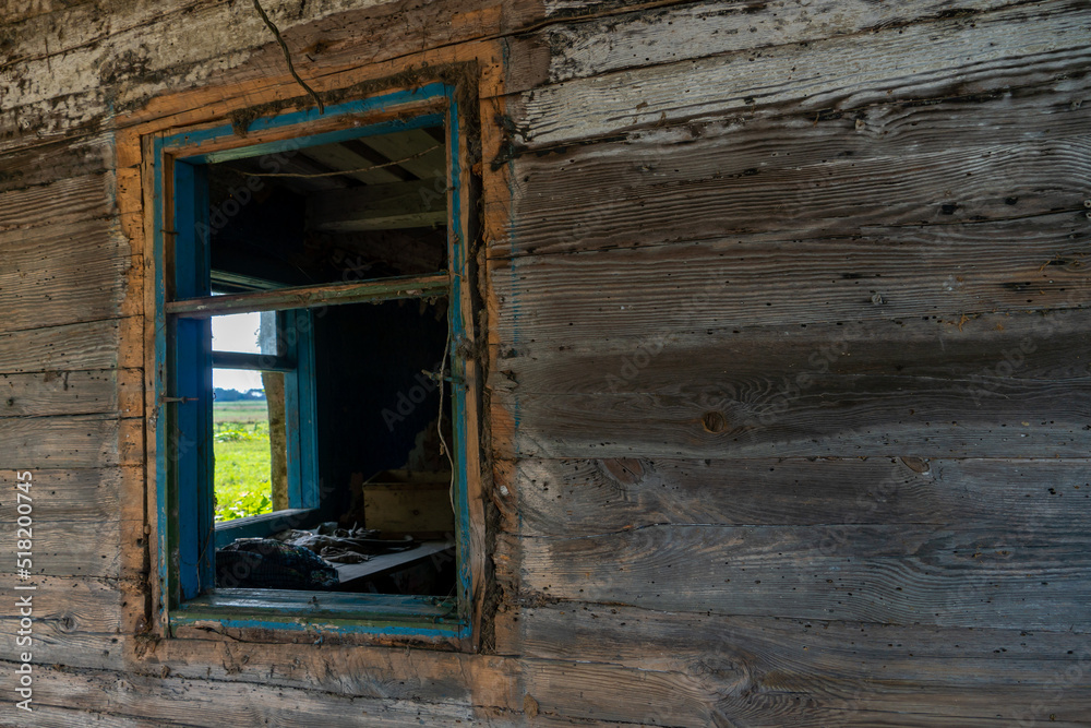 An old wooden uninhabited house. A small house in the village with a sunken roof and walls overgrown with moss. Destroyed housing after the cataclysm and poverty in Russia. An old wooden uninhabited house. A small house in the village with a sunken roof and walls overgrown with moss. Destroyed housing after the cataclysm and poverty in Russia.