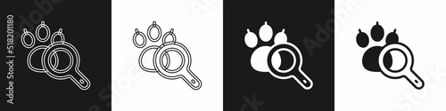 Set Paw search icon isolated on black and white background. Magnifying glass with animal footprints. Vector