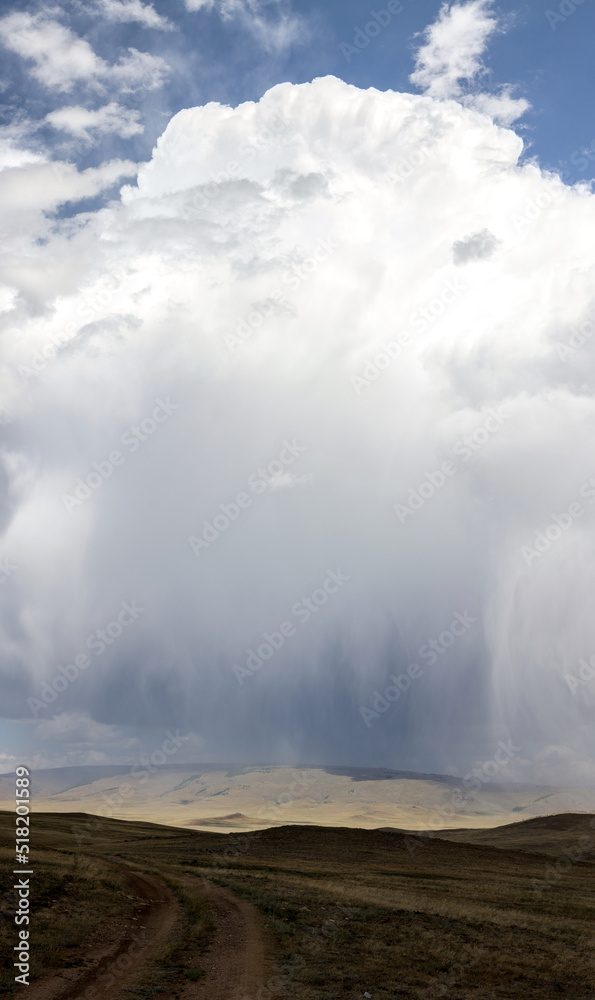 gigantic rain cloud in the hilly landscape gigantic rain cloud in the hilly landscape