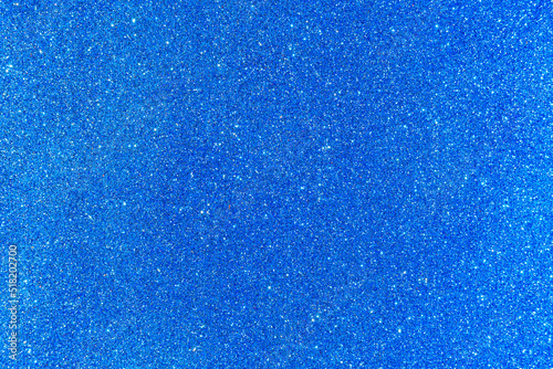 Background with sparkles. Backdrop with glitter. Shiny textured surface. Strong blue photo