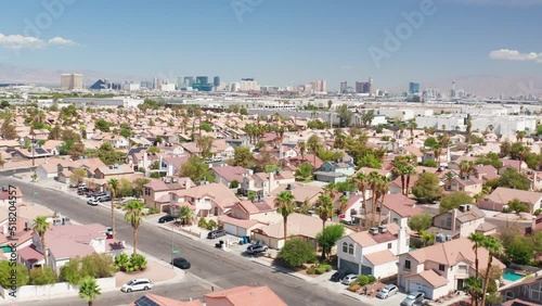 Aerial view of Las Vegas residential homes next to airport with city skyline photo