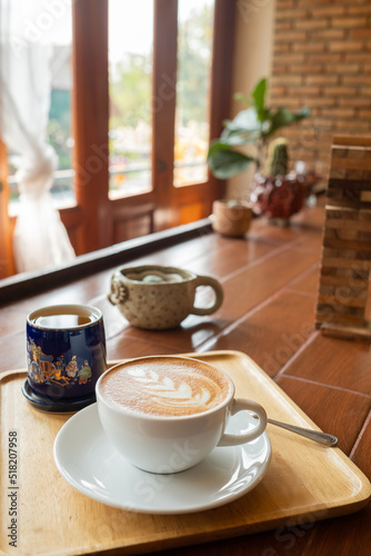 Fototapeta Naklejka Na Ścianę i Meble -  hot latte art coffee on wood table, relax time
