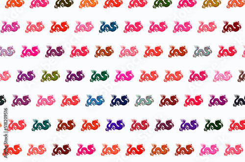 Row of colored dragon polka on white background
