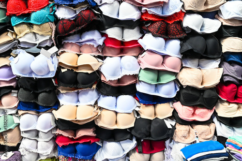 Bras for sale in market. Colorful bras on stall in shop. 