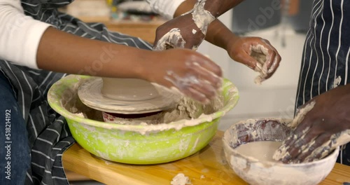 Black couple in love working together on potter wheel