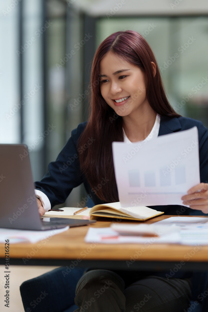 Consult financial concept. Business woman pointing at paperwork and using calculator on desk at office. back to office. Consult financial concept. Business woman pointing at paperwork and using calculator on desk at office. back to office.