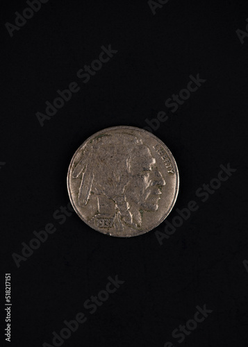 Photograph of a 1937 Buffalo Nickle on black background. photo