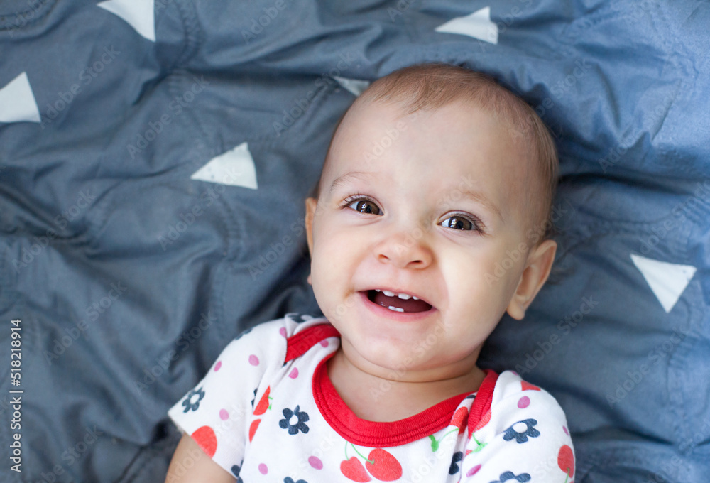 the baby is smiling lying on the blanket the baby is smiling lying on the blanket