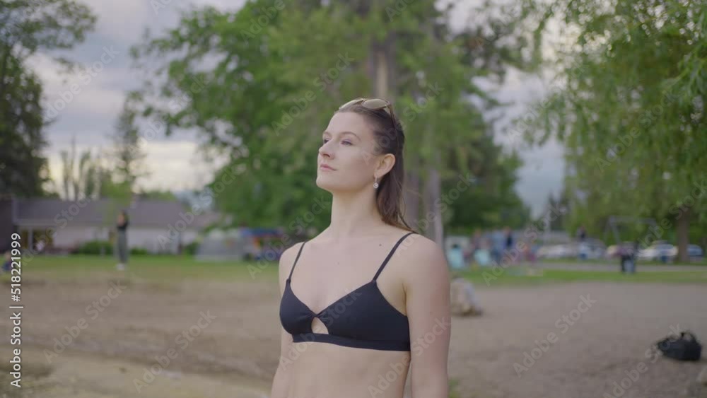 Front view of attractive girl walking away on a beach