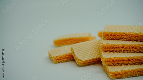 Tasty wafer sticks on white background, flat lay. Sweet food
