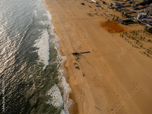 Aerial view of fishermen pulling in catch on beach in Cotonou, Benin.