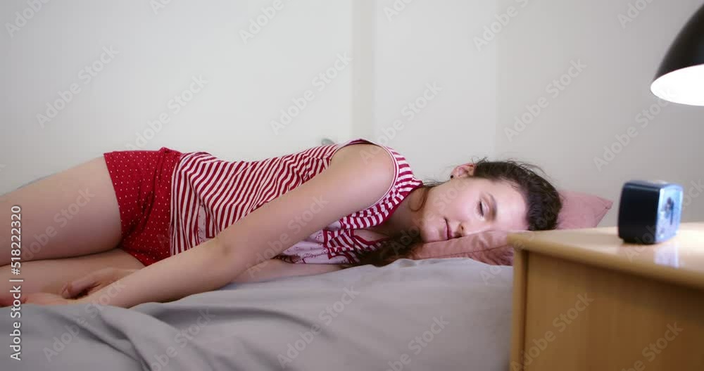 Exhausted or totally tired girl fell to bed sleeping in slow motion, middle shot view
