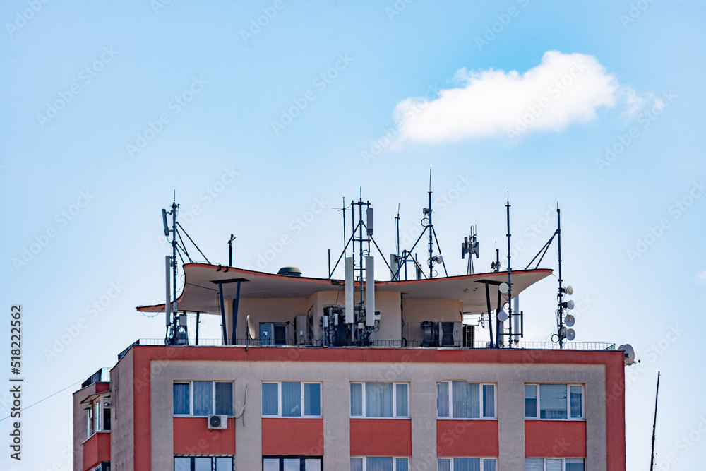 5G antennas on the roof of an apartment building fir a better signal coverage in the urban area