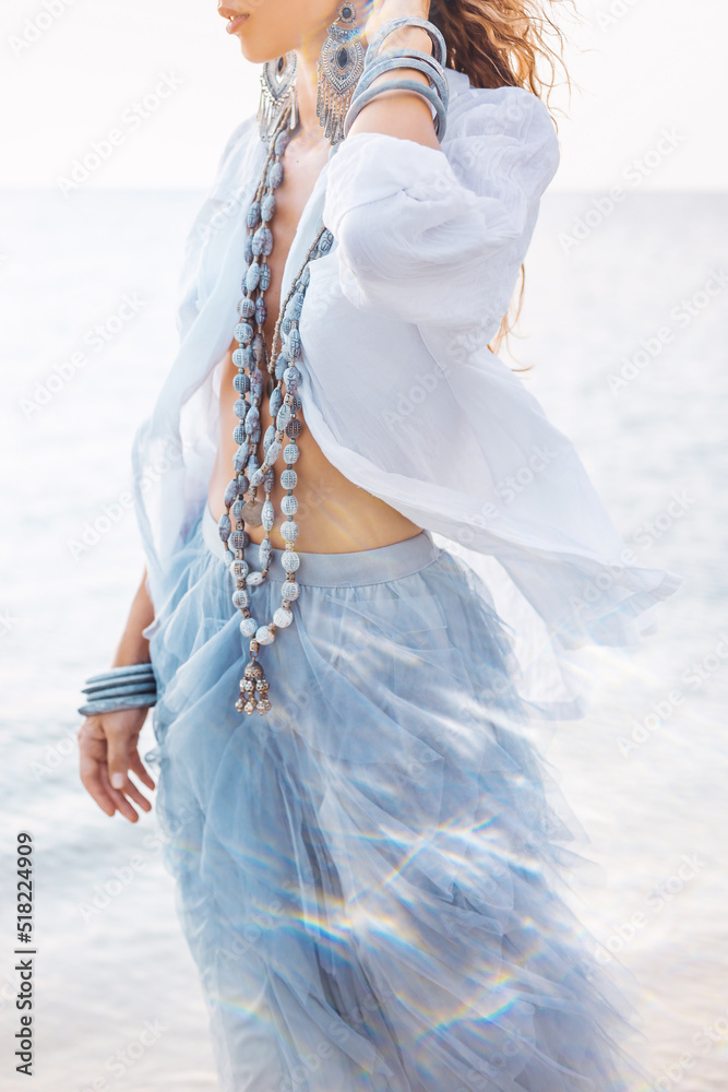 Fototapeta premium beautiful young stylish woman walking on the beach close up