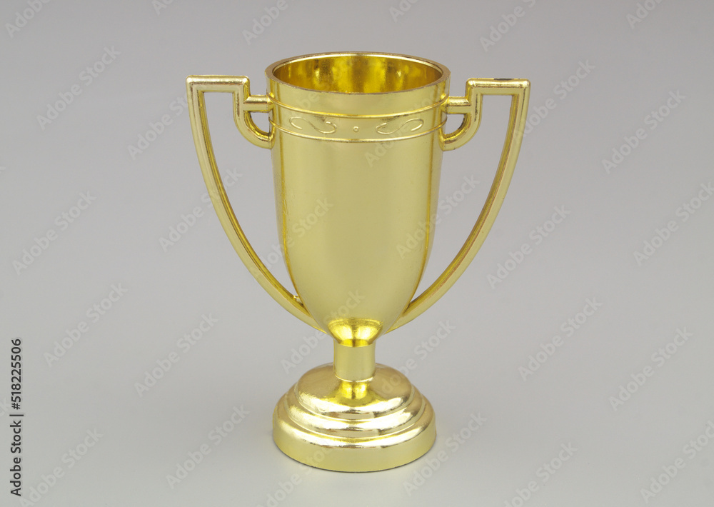 Gold trophy cup on gray background Gold trophy cup on gray background