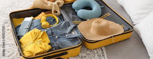 Open packed suitcase on bed...
