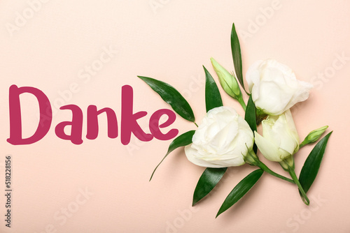 Beautiful flowers and word DANKE (German for Thanks) on pink background