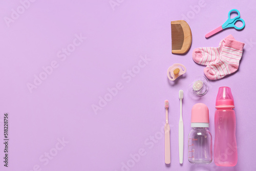 Different baby accessories on color background