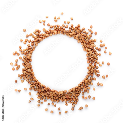Frame made of dry buckwheat grains on white background