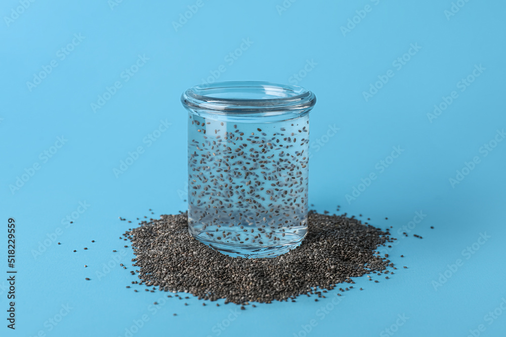 Glass of water with chia seeds on blue background Glass of water with chia seeds on blue background