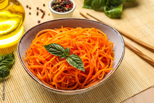Bowl of delicious korean carrot salad on table, closeup