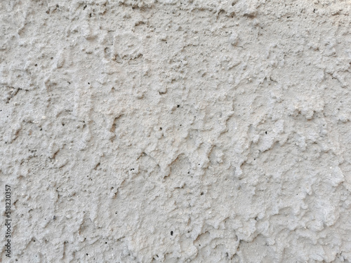 Unfinished stucco concrete wall texture background.  Rough cement wall background.
