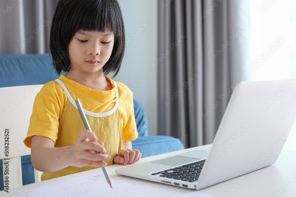 little asian girl student study online using laptop computer at home little asian girl student study online using laptop computer at home