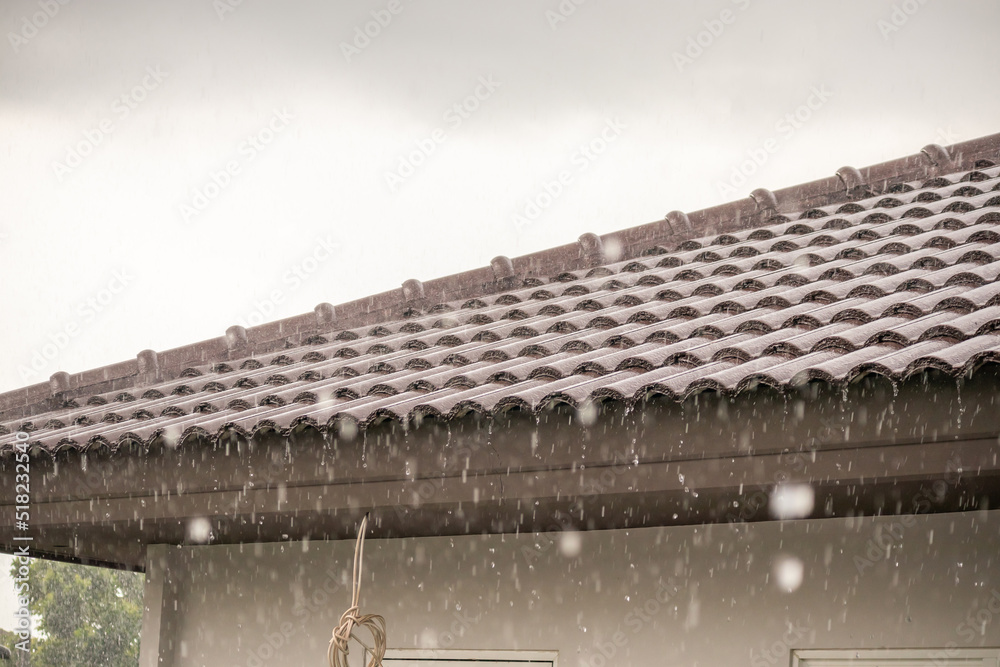 Fototapeta premium rain falling down from the house roof