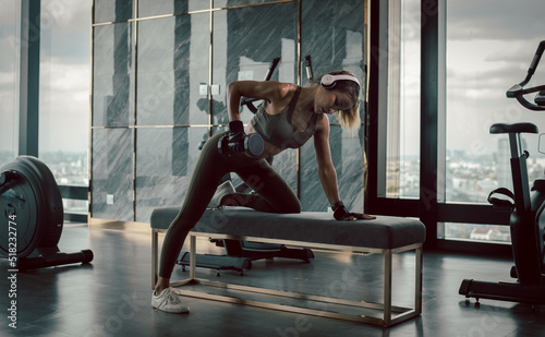 Fototapeta Naklejka Na Ścianę i Meble -  Sport beautiful fitness woman wear sportwear posing under exercise with dumbbell equipment at gym ,she exercise for strong ,make muscle body building and good healthy concept.