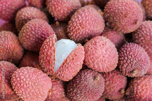 Fresh lychee fruits with one cut open in full frame (manual focus)