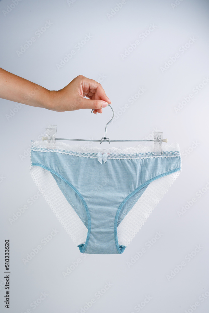 Women's panties isolated on white background. The girl holds panties in ...