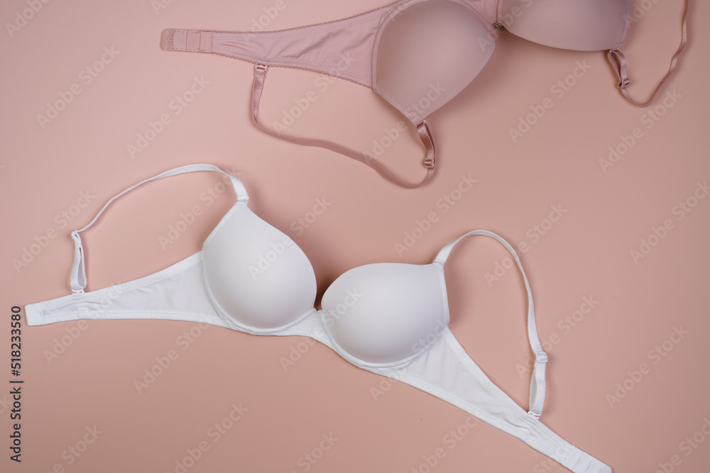 Beautiful beige and 
white sexy bra. Romantic lingerie. Top view. Morning concept. Morning routine of getting ready for work or romantic date