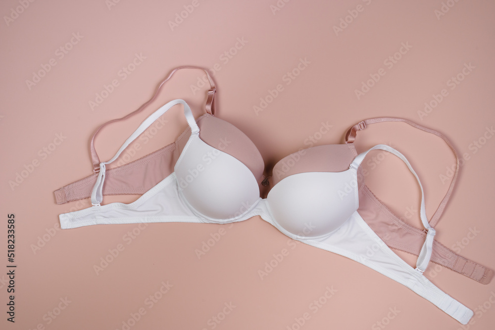 Beautiful beige and
white sexy bra. Romantic lingerie. Top view. Morning concept. Morning routine of getting ready for work or romantic date Beautiful beige and
white sexy bra. Romantic lingerie. Top view. Morning concept. Morning routine of getting ready for work or romantic date