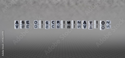 age discrimination word or concept represented by black and white letter cubes on a grey horizon background stretching to infinity