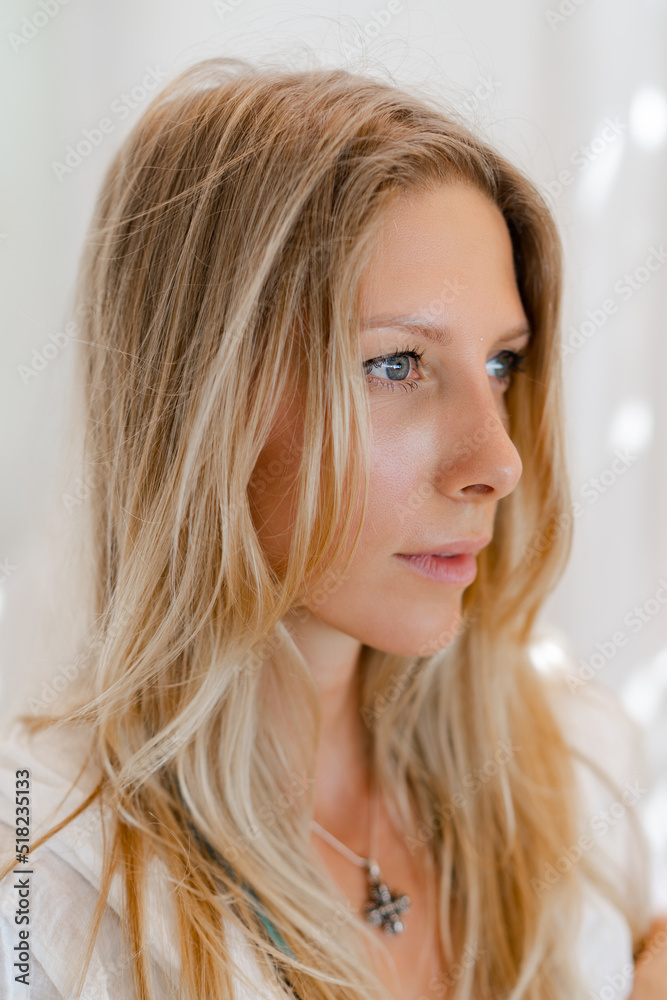 Fashion photo of beautiful blond woman in white summer clothes posing in modern hotel during vacations. Fashion photo of beautiful blond woman in white summer clothes posing in modern hotel during vacations.