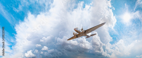 Quadro su tela Metallic airplane old propeller in the sky, Stormy clouds in the background