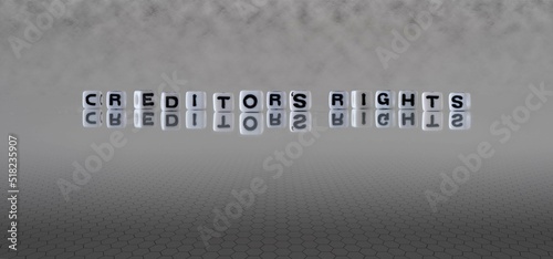 creditor's rights word or concept represented by black and white letter cubes on a grey horizon background stretching to infinity